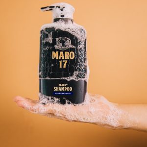 a hand holding a bottle of alcohol